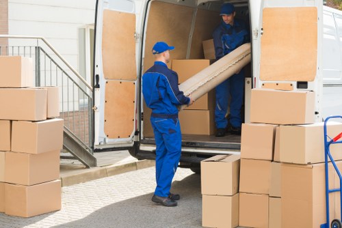 Local home moving service in Morden with packed boxes and moving van