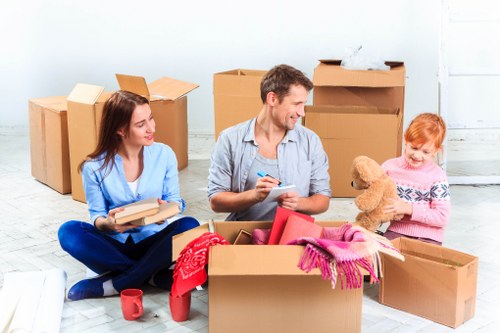 Local office movers preparing equipment and furniture for relocation in Morden