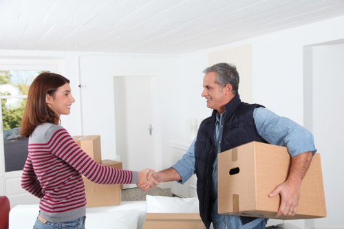 Removal team handling furniture and boxes in Morden