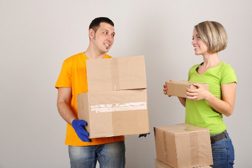 Professional removals team handling boxes and furniture in a Morden property