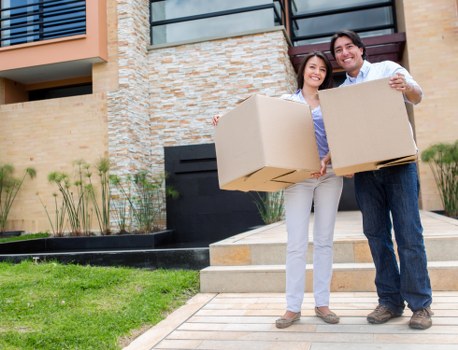 Packed boxes and furniture loaded into a moving truck in Morden