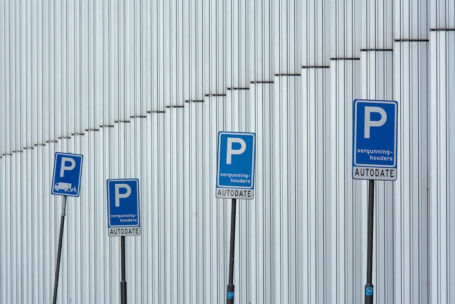 A rectangular metal sign mounted on a rough stone wall, displaying the text 'PARKING WITH HOTEL PERMIT ONLY' in bold black capital letters. The sign is secured with four screws, one at each corner. The wall behind the sign consists of large, uneven sandstone blocks with visible mortar joints. The scene appears to be outdoors, possibly near a building entrance or parking area, with natural light illuminating the textured stones. This signage may be relevant to vehicle restrictions during a home relocation or furniture transport process managed by Man with Van Morden, especially when parking permits are required for efficient loading and unloading outside the property.